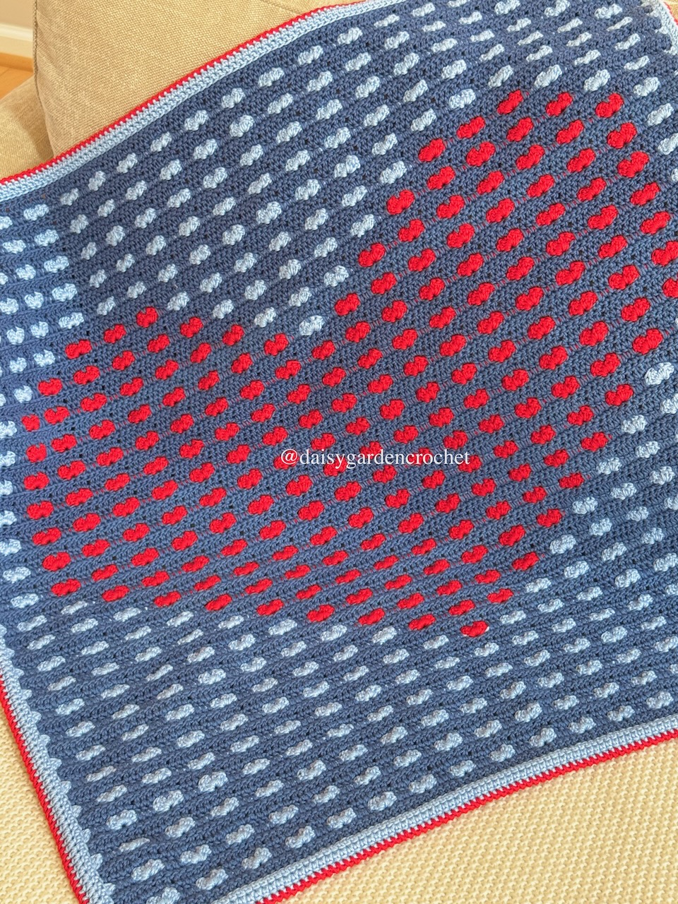 Crochet blanket made using the heart stitch in the shape of a big heart